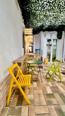 a patio with two chairs and a table and chairs at NEW GENERATION HOSTEL Prague center in Prague