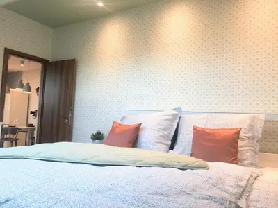 a bedroom with a large bed with orange pillows at ATTIC APARTMENT on WATERFRONT / VIEW / NETFLIX in Prague