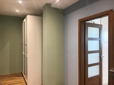 a room with green walls and a door at ATTIC APARTMENT on WATERFRONT / VIEW / NETFLIX in Prague