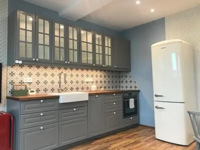 a kitchen with gray cabinets and a white refrigerator at ATTIC APARTMENT on WATERFRONT / VIEW / NETFLIX in Prague