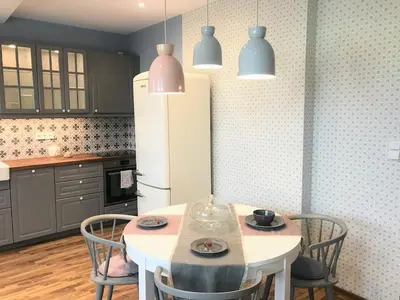 a kitchen with a white table and chairs and a refrigerator at ATTIC APARTMENT on WATERFRONT / VIEW / NETFLIX in Prague