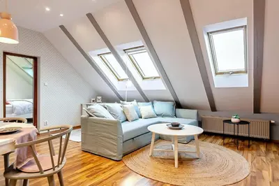 a living room with a couch and a table at ATTIC APARTMENT on WATERFRONT / VIEW / NETFLIX in Prague
