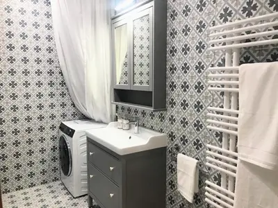 a bathroom with a sink and a washing machine at ATTIC APARTMENT on WATERFRONT / VIEW / NETFLIX in Prague