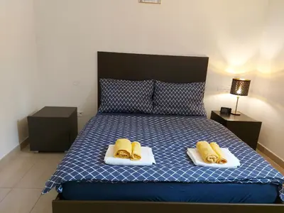 a bedroom with a bed with two hot dogs on towels at quiet apartment in Prague center in Prague