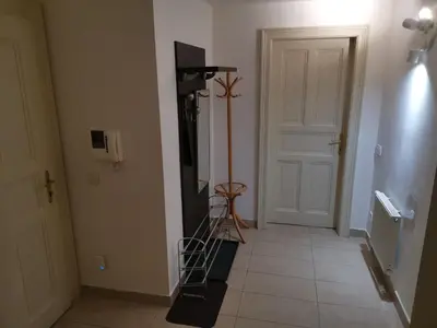 a hallway with a room with a television and a tripod at quiet apartment in Prague center in Prague