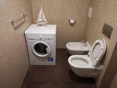 a bathroom with a washing machine and a toilet at quiet apartment in Prague center in Prague