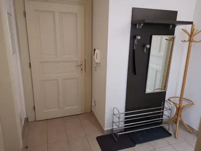 a hallway with a black refrigerator and a door at quiet apartment in Prague center in Prague