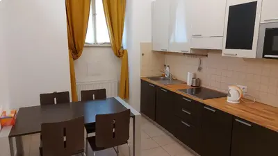 a kitchen with a table and chairs and a counter at quiet apartment in Prague center in Prague