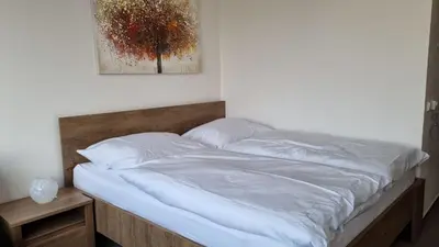 a bed with white sheets and pillows in a bedroom at Pension Vinařství Klučov in Klučov