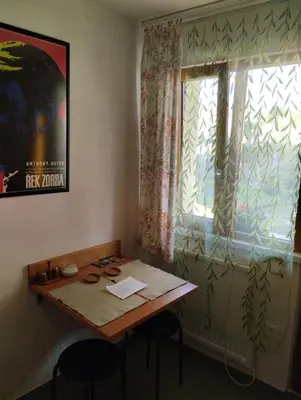 a table and chairs in a room with a window at Malé útulné studio s koupelnou a kuchyňkou in Svinařov