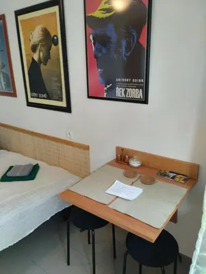a room with a table and a bed at Malé útulné studio s koupelnou a kuchyňkou in Svinařov