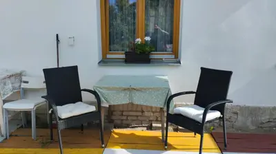 a table and chairs in a room with a window at Malé útulné studio s koupelnou a kuchyňkou in Svinařov