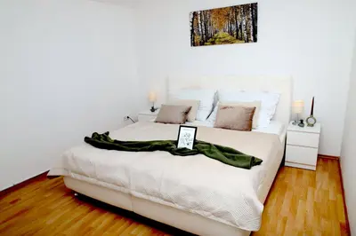 a bedroom with a white bed with a picture on the wall at Valnovka Wellness Hotel in Kamenice