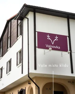 a sign on the side of a building at Valnovka Wellness Hotel in Kamenice