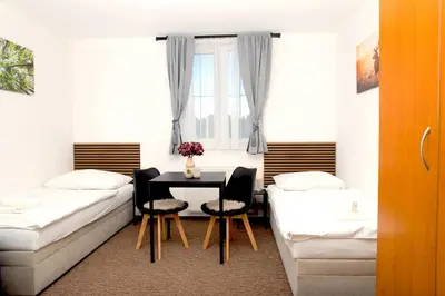 a hotel room with two beds and a window at Valnovka Wellness Hotel in Kamenice