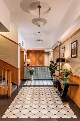 a lobby of a hotel with a tile floor at Hotel Golfi in Poděbrady