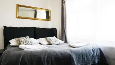 a bedroom with a bed with two pillows and a mirror at Hostel V38 in Prague