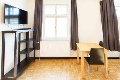 a dining room with a table and a window at Hostel V38 in Prague