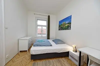 a small bedroom with a bed and a window at Peter's Tower Apartments in Prague