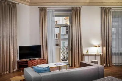 a living room with a couch and a tv at Golden Angel Suites by Adrez in Prague