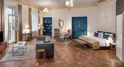 a bedroom with a bed and a living room at Golden Angel Suites by Adrez in Prague