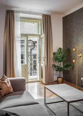 a living room with a couch and a table at Golden Angel Suites by Adrez in Prague