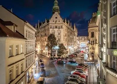a view of a city street at night with cars parked at Golden Angel Suites by Adrez in Prague