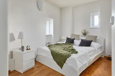 a bedroom with a bed and a staircase at Prague Days - Loft with Relax Zone near Vltava River in New Town in Prague