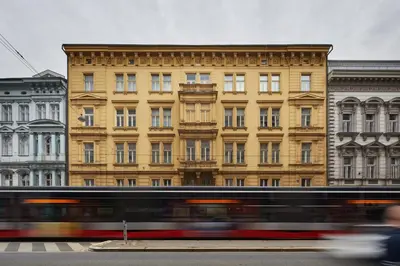 a bus in front of a large building at Prague Days - Loft with Relax Zone near Vltava River in New Town in Prague
