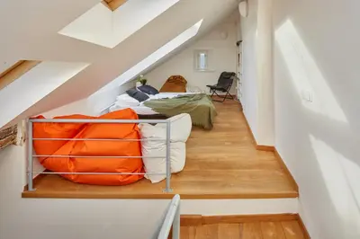 an attic room with a bed and a staircase at Prague Days - Loft with Relax Zone near Vltava River in New Town in Prague