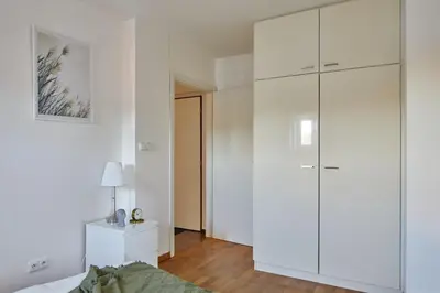 a bedroom with white cabinets and a bed at Prague Days - Loft with Relax Zone near Vltava River in New Town in Prague