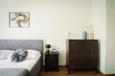 a bedroom with a bed and a dresser at Apartmán Anastasie in Prague