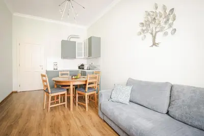 a living room with a couch and a table and a kitchen at Apartmán Anastasie in Prague
