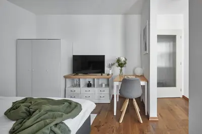 a bedroom with a desk and a bed and a chair at Prague Days - Deluxe Apartments near Wenceslas Square in Prague