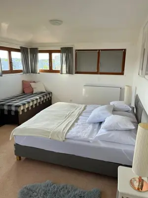 a bedroom with a large bed and a couch at Residence Sarka Top in Prague
