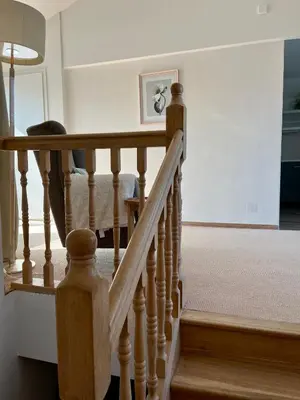 a staircase in a home with a wooden railing at Residence Sarka Top in Prague