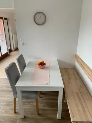 a white table with chairs and a bowl of fruit on it at Residence Sarka Top in Prague