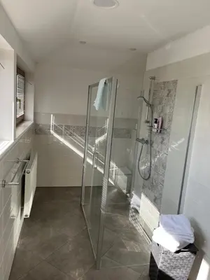 a bathroom with a shower and a glass shower stall at Residence Sarka Top in Prague