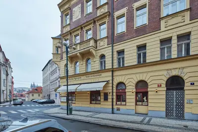 a staircase in a building with a metal railing at Prague Days - One-bedroom Apartment with Balcony and Elevated Chill Zone in Old Town in Prague