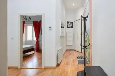 a bedroom with a large wooden cabinet next to a door at Prague Days - One-bedroom Apartment with Balcony and Elevated Chill Zone in Old Town in Prague