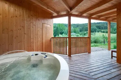 a bath tub in a room with a wooden deck at Smilovický Mlýn in Rakovník