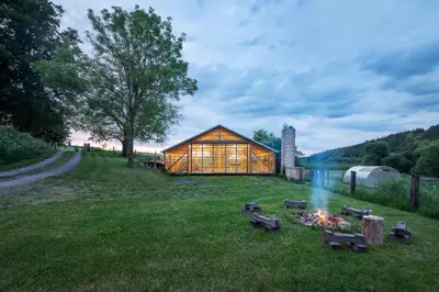 a cabin in the grass with a fire in the yard at Smilovický Mlýn in Rakovník