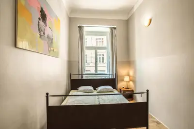 a bedroom with a bed and a window at Ahoy! Hostel in Prague