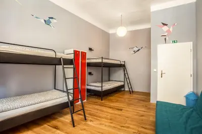 a room with two bunk beds and a door at Ahoy! Hostel in Prague