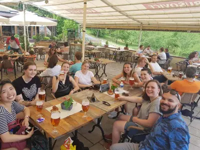 a group of people sitting at tables in a restaurant at Ahoy! Hostel in Prague