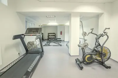 a gym with a treadmill and a exercise bike at Wellness studio! Finnish sauna, Whirlpool, Gym & more! in Prague