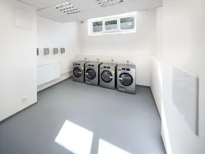 a laundry room with three washing machines in it at Wellness studio! Finnish sauna, Whirlpool, Gym & more! in Prague