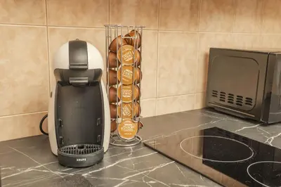 a coffee maker sitting on a counter next to a microwave at Wellness studio! Finnish sauna, Whirlpool, Gym & more! in Prague