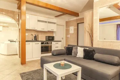 a living room with a couch and a table at Wellness studio! Finnish sauna, Whirlpool, Gym & more! in Prague