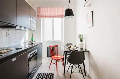 a small kitchen with a table and chairs in it at Prague Days - One-bedroom Apartment with Netflix and Workspace with iMac in New Town in Prague
